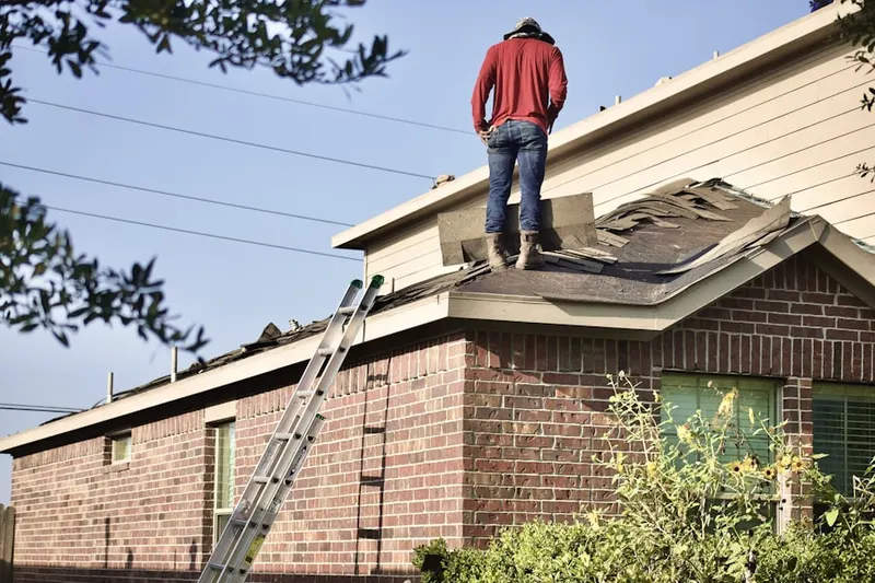 Professional roofer working on a residential roof in Oak Orchard